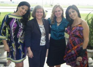Twin sisters Jill Kelley and Natalie Khawam pose with David Petraeus' wife, Holly, and daughter, Anne