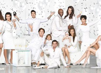Kendall Jenner had no trouble stealing the limelight from her big sisters as she posed in backless dress for the annual Kardashian-Jenner Christmas card