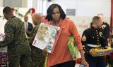 Michelle Obama delivered about 900 gifts to the Marine Corps’ Toys for Tots campaign but perhaps lost in the seriousness of her mission, forgot to wear her smile