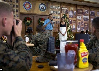 President Barack Obama and First Lady Michelle Obama wished the troops a merry Christmas with a visit to a Marine base in Hawaii on Tuesday