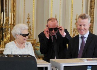 Queen Elizabeth II wore dark glasses with a glittering Swarovski Q on each side while she was watching a preview of her Christmas message