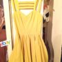 eBay Yellow Skater Dress: Aimi Jones captured herself half-na**d in a mirror when she snapped a dress to sell on eBay