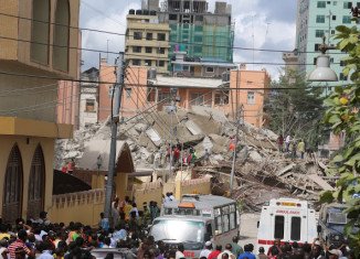 At least three people have been killed and dozens more are trapped after a multi-storey building collapsed in Dar es Salaam