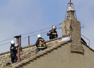 Firefighters have fitted a chimney on top of the Sistine Chapel in the Vatican ahead of the conclave which will elect a new pope