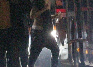 Justin Bieber ditched his top and was seen walking back to his tour bus with his shirt slung over his shoulder in Frankfurt on Thursday