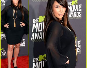 Kim Kardashian flattered her pregnant figure in a sexy black dress on the red carpet at the 2013 MTV Movie Awards