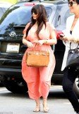 Kim Kardashian had another unflattering choice of maternity wear with a salmon pink dress that billowed dramatically at the hips as she attended church with her mother Kris Jenner