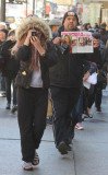 On her 27th birthday, Amanda Bynes was snapped taking a picture of paparazzi and hiding her face with a man in the background holding up a tabloid spread about her