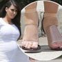 Kim Kardashian squeezes her swollen feet into perspex stilettos