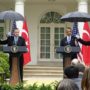 Barack Obama makes U.S. Marine break military rules by holding an umbrella while in uniform