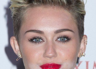 Miley Cyrus had a visible layer of white powder around her chin after suffering a make-up malfunction while glamming up to celebrate her title as Maxim's hottest woman