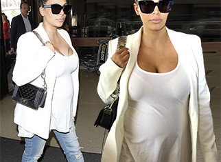 Pregnant Kim Kardashian drew attention to herself as she arrived at LAX thanks to her low-cut top
