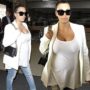 Pregnant Kim Kardashian wearing white low-cut top as she arrives at LAX