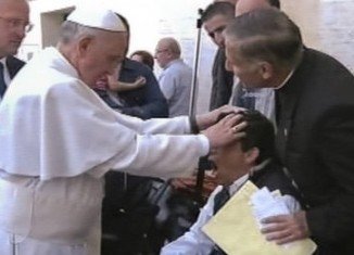 TV 2000 images show a man apparently reacting to Pope Francis putting his hands on his head