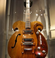 The guitar played by John Lennon and George Harrison of the Beatles has sold for $408,000 at auction