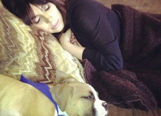 Kim Kardashian has shown up on Khloe's Facebook page looking exhausted and enjoying a nap with boxer pup Bernard