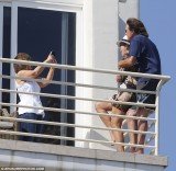 Kris and Bruce Jenner were spotted laughing and hugging on the balcony of Bruce's temporary seaside home in Malibu with their daughters Kendall and Kylie