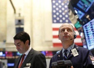 US shares closed at record levels after the Federal Reserve indicated that its efforts to boost the economy would continue for now