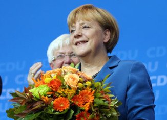 Angela Merkel has urged her party to celebrate "a super result" after exit polls suggested CDU was set to win a third term