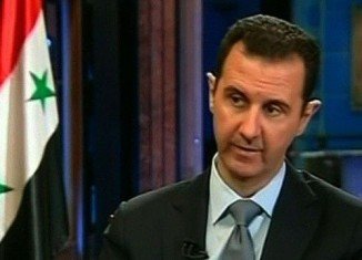Bashar al-Assad has said he is committed to a plan to destroy his country's chemical weapons but warned it could take about a year