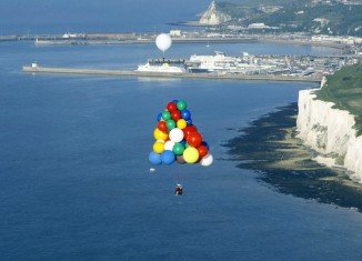 Jonathan Trappe is trying to cross the Atlantic in a lifeboat suspended by some 370 multicolored helium balloons