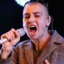 Sinead O’Connor displays face tattoos while onstage at Bestival