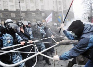 Police fired tear gas as protesters tried to break through a cordon around government buildings