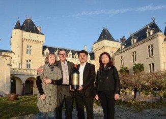 Lam Kok and James Gregoire pictured with their wives while celebrating the sale of the chateau