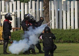 Thai riot police have fired teargas at protesters trying to prevent political parties from registering for February's elections