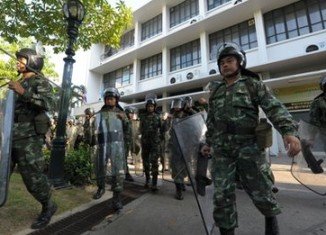 Troops have been deployed in Bangkok to support riot police shielding official buildings from anti-government protesters