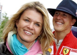 Corinna Schumacher has appealed for privacy and for reporters to leave the clinic where Michael Schumacher is being treated