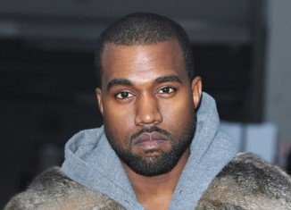 Kanye West has reportedly settled with the 18-year-old who incurred his wrath by hurling racial epithets at Kim Kardashian