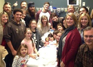 Mia Robertson with a large swath of her extended family at her bedside