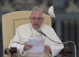 A gust of wind blows away Pope Francis' skull cap, or zuchetto, as he delivers his message during his weekly general audience in St. Peter's Square at the Vatican