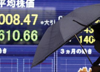 Asian shares fell after the US Federal Reserve hinted that it might raise interest rates as soon as 2015
