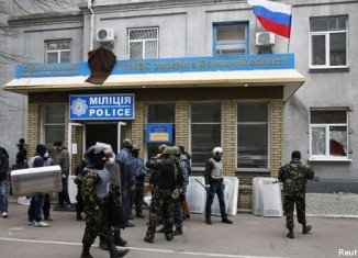Armed men took over police stations and official buildings in Sloviansk and two other eastern towns