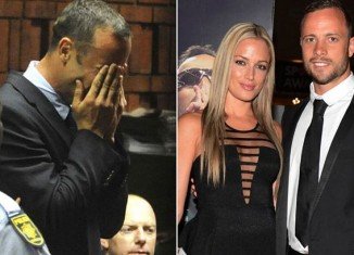 Oscar Pistorius became distraught as he was shown a photo of his dead girlfriend Reeva Steenkamp by the prosecution at his murder trial in Pretoria
