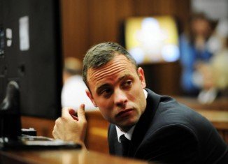 Oscar Pistorius has started his testimony at his murder trial in Pretoria by apologizing to the family of his girlfriend Reeva Steenkamp