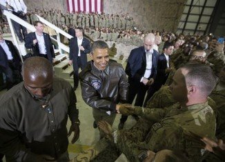 Barack Obama was cheered by soldiers during a surprise visit to Bagram Airfield outside Kabul