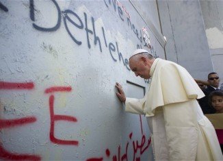 Pope Francis has prayed at Bethlehem wall during his three-day tour of the Middle East