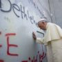 Pope Francis prays at Bethlehem wall during Middle East tour