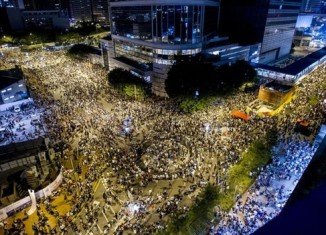 Tens of thousands of protesters have blocked the streets of Hong Kong, shutting down businesses and ignoring appeals to leave