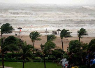Hundreds of thousands of people are evacuated as Cyclone Hudhud pounds the eastern Indian coast