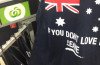 The singlet bearing a slogan seen by many as racist was on sale at two Woolworths stores in Queensland and New South Wales